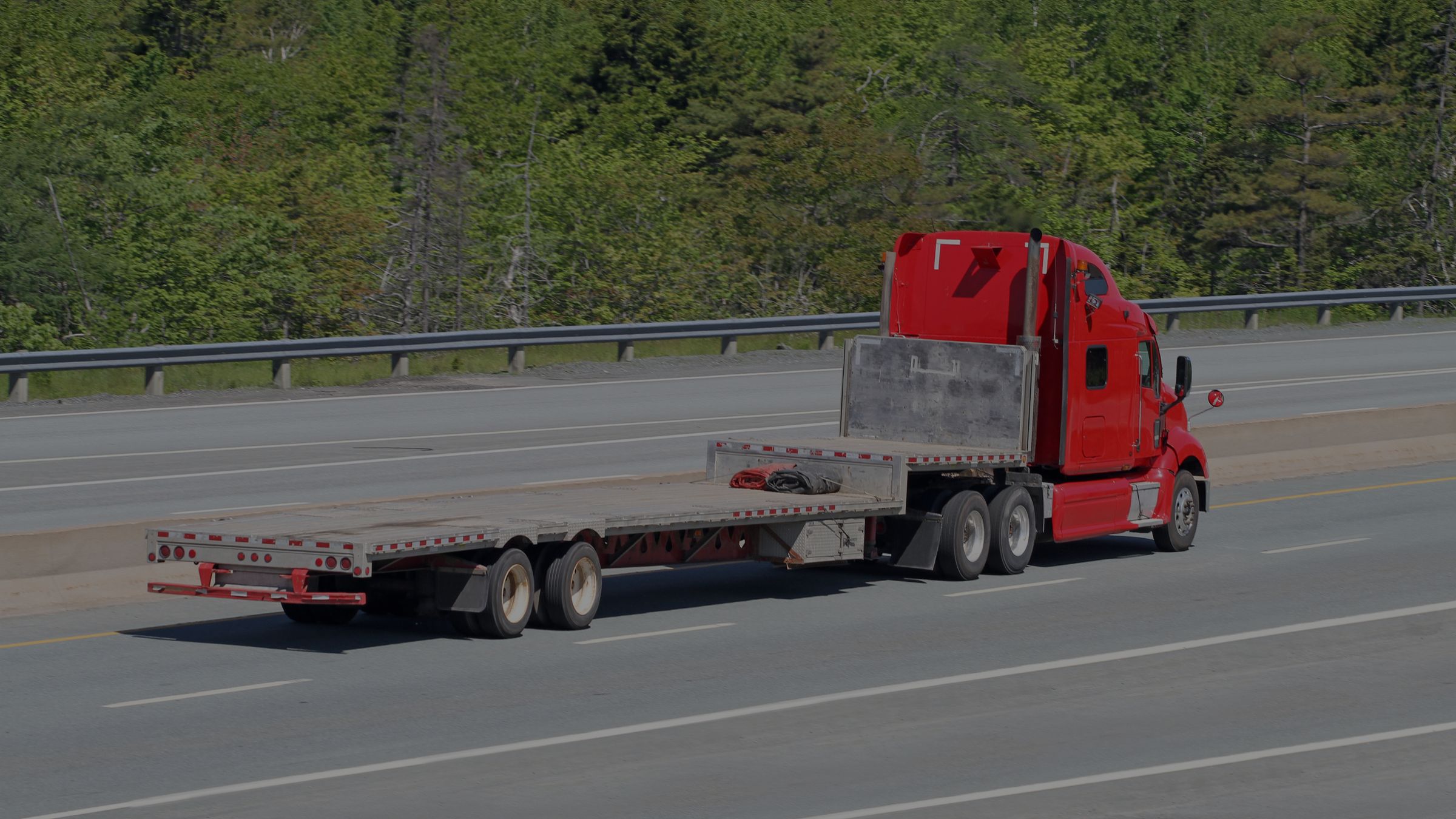 Flatbed trailers staged in a yard at dawn
